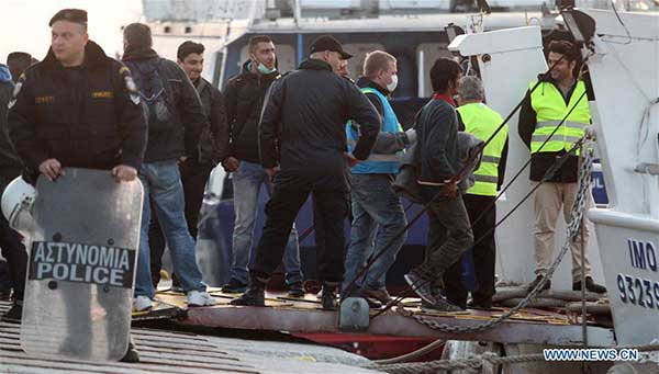 Migrants get on a ferry at the port of Mytilini on the Greek island of Lesbos April 4, 2016, the first day of the implementation of the deal between the European Union and Turkey. Under the deal, migrants arriving illegally in Greece will be returned to Turkey if they do not apply for asylum, or if they make an asylum claim that is rejected. [Photo:Xinhua/Marios Lolos]