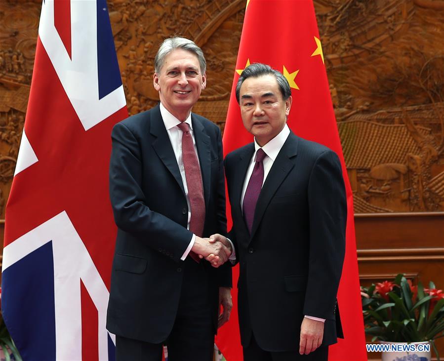 BEIJING, April 9, 2016 (Xinhua) -- Chinese Foreign Minister Wang Yi (R) meets with visiting British Foreign Secretary Philip Hammond in Beijing, capital of China, April 9, 2016. (Xinhua/Pang Xinglei)