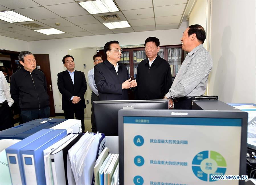 Chinese Premier Li Keqiang (3rd R) visits the Ministry of Human Resources and Social Security in Beijing, capital of China, May 6, 2016. Li Keqiang inspected the Ministry of Human Resources and Social Security on May 6, urging for more efforts to support employment to guard against large-scale unemployment. (Xinhua/Li Tao)