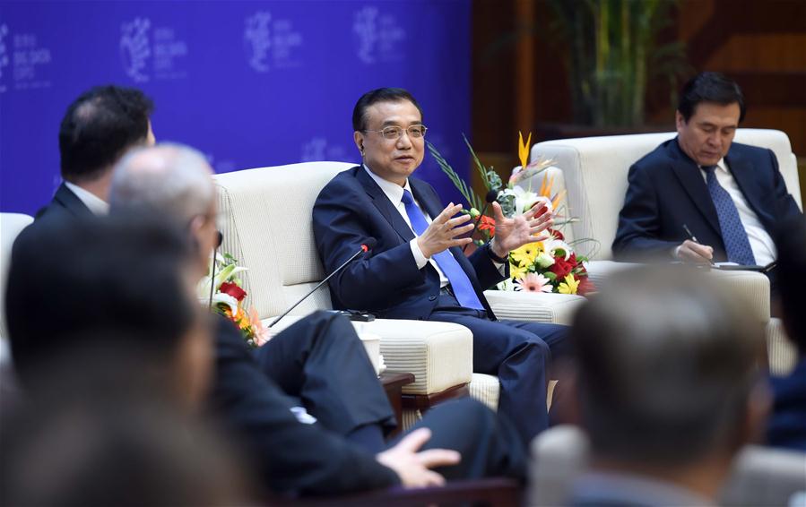 Chinese Premier Li Keqiang talks with business leaders on the sidelines of the China Big Data Industry Summit & China E-commerce Innovation and Development Summit in Guiyang, capital of southwest China