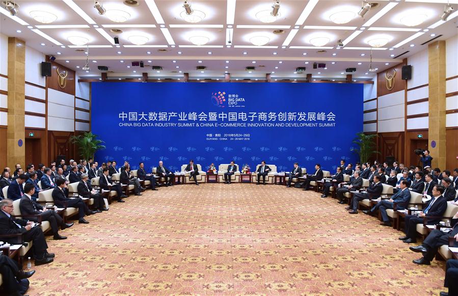 Chinese Premier Li Keqiang talks with business leaders on the sidelines of the China Big Data Industry Summit & China E-commerce Innovation and Development Summit in Guiyang, capital of southwest China