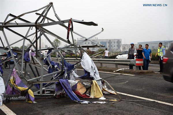 Photo taken on June 23, 2016 shows a steel tower blown down by tornado in Funing County, east China