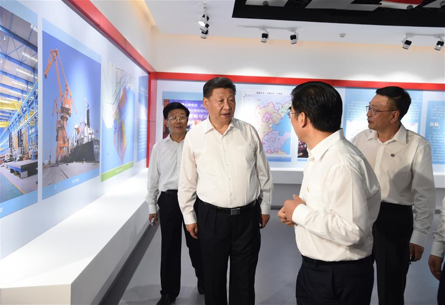 Chinese President Xi Jinping (2nd L), who is also general secretary of the Communist Party of China (CPC) Central Committee and chairman of the Central Military Commission (CMC), visits an exhibition on the city