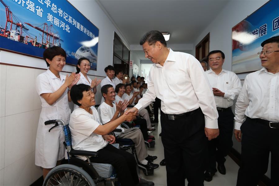 Chinese President Xi Jinping (2nd R front), who is also general secretary of the Communist Party of China (CPC) Central Committee and chairman of the Central Military Commission (CMC), visits paraplegic patients at the city
