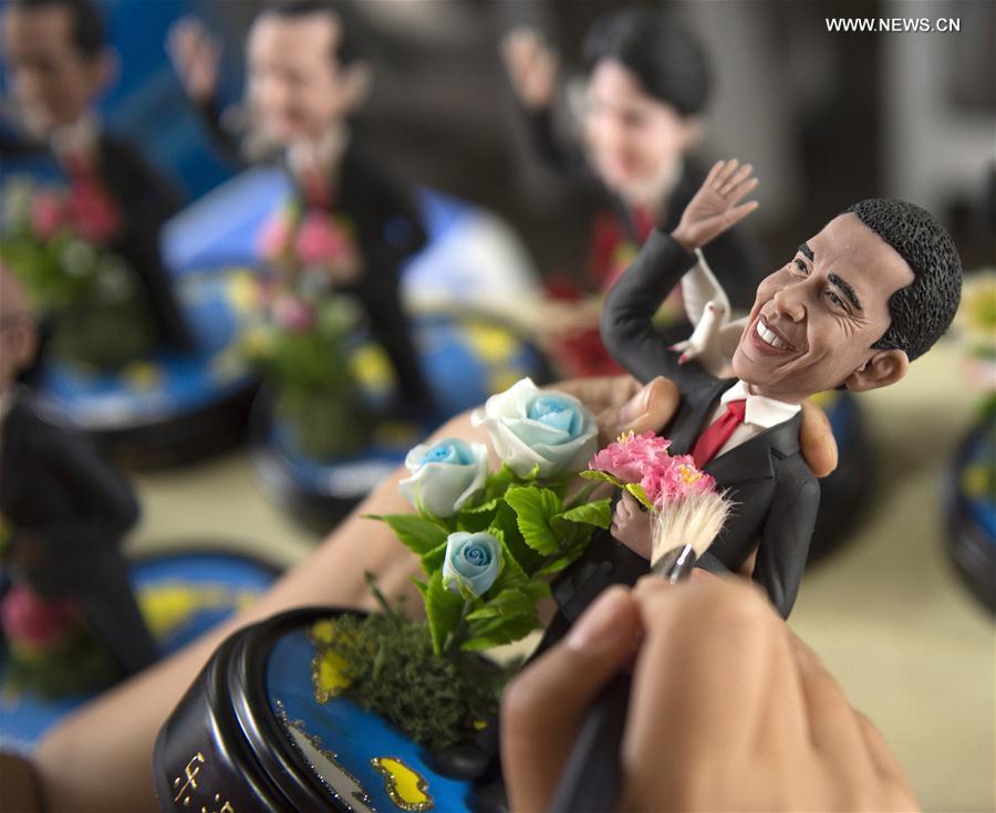 Artist Wu Xiaoli finishes a clay figure featuring the U.S. President Barack Obama prior to the upcoming G20 Summit in Hangzhou, capital of east China
