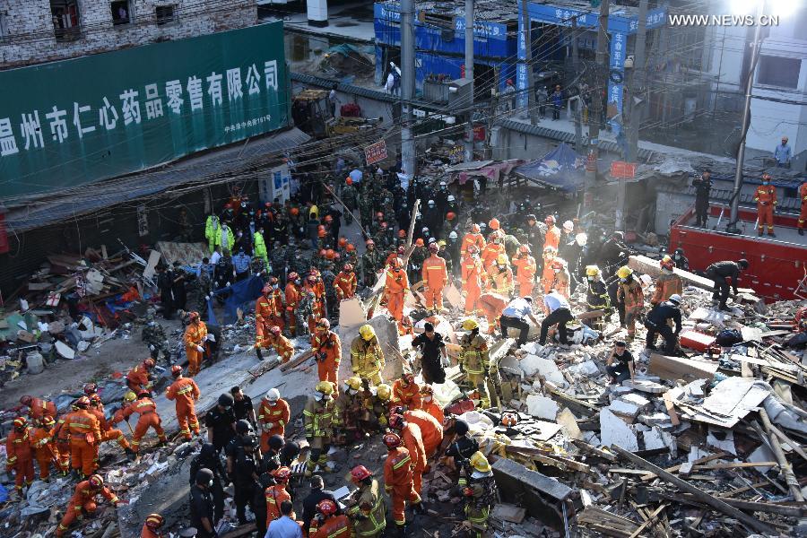   Rescuers work at the accident site after buildings collapsed in Wenzhou City, east China