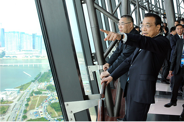 Premier Li Keqiang, right, climbs to the top of Macao Tower on Oct 10 accompanied by Macao&rsquo;s Chief Executive Chui Sai On, left. [Photo/provided to chinadaily.com.cn]
