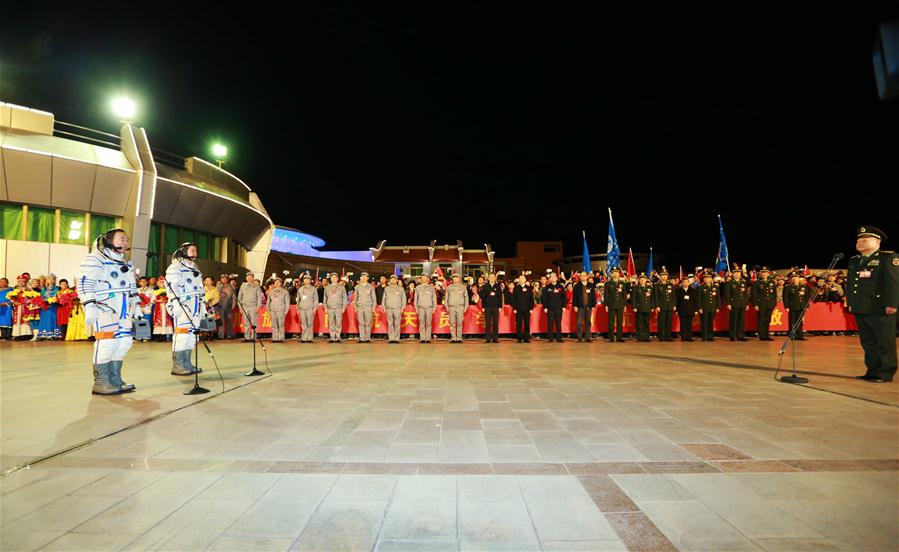 Taikonauts Jing Haipeng (L) and Chen Dong attend the see-off ceremony of the Shenzhou-11 manned space mission at the Jiuquan Satellite Launch Center in Jiuquan, northwest China