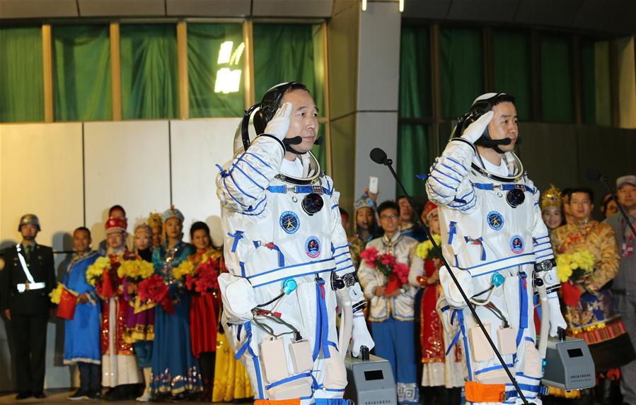 Taikonauts Jing Haipeng (L) and Chen Dong attend the see-off ceremony of the Shenzhou-11 manned space mission at the Jiuquan Satellite Launch Center in Jiuquan, northwest China