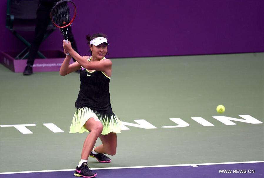 Peng Shuai of China returns the ball during the women