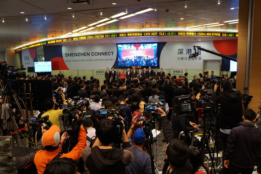 The Shenzhen-Hong Kong Stock Connect, the second link between the mainland and Hong Kong bourses, is launched on Monday, Dec. 5, 2016. Ceremonies were held simultaneously at Hong Kong and Shenzhen bourses via video link as Hong Kong Exchanges and Clearing (HKEX) Chairman Chow Chung-kong and Hong Kong Chief Executive Leung Chun-ying jointly beat a gong to mark the launch. [Photo: CRIENGLISH.com/Ding Yiming] 