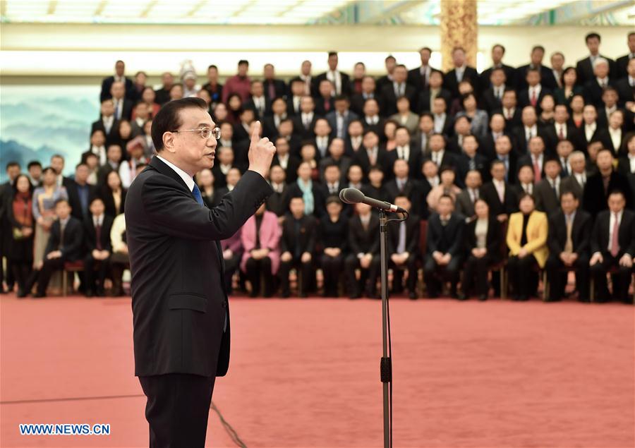 Chinese Premier Li Keqiang speaks during a meeting with representatives of China