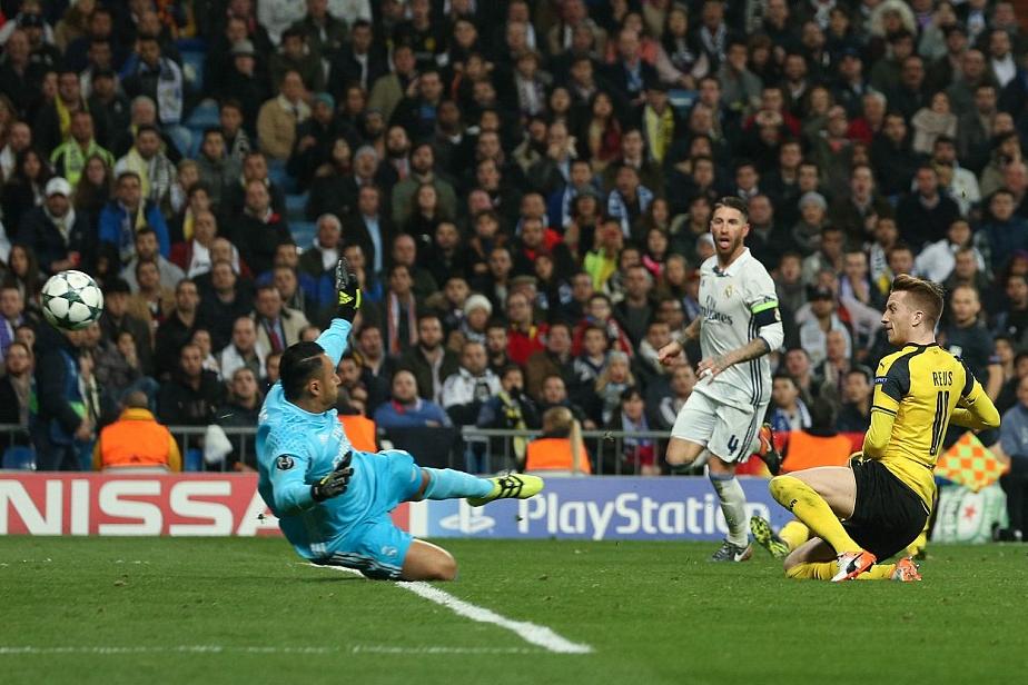 Marco Reus fires the ball past Real Madrid goalkeeper keylor Navas to level the scores as a shocked Sergio Ramos looks on.