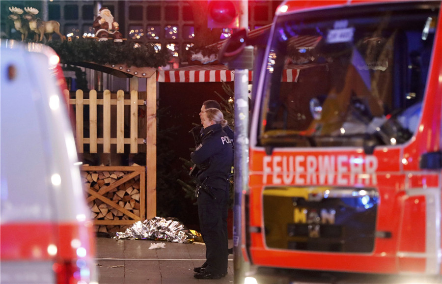 Police stand guard at a Christmas market in Berlin, Germany, Dec 19, 2016 after a truck ploughed into the crowded Christmas market in the German capital. 