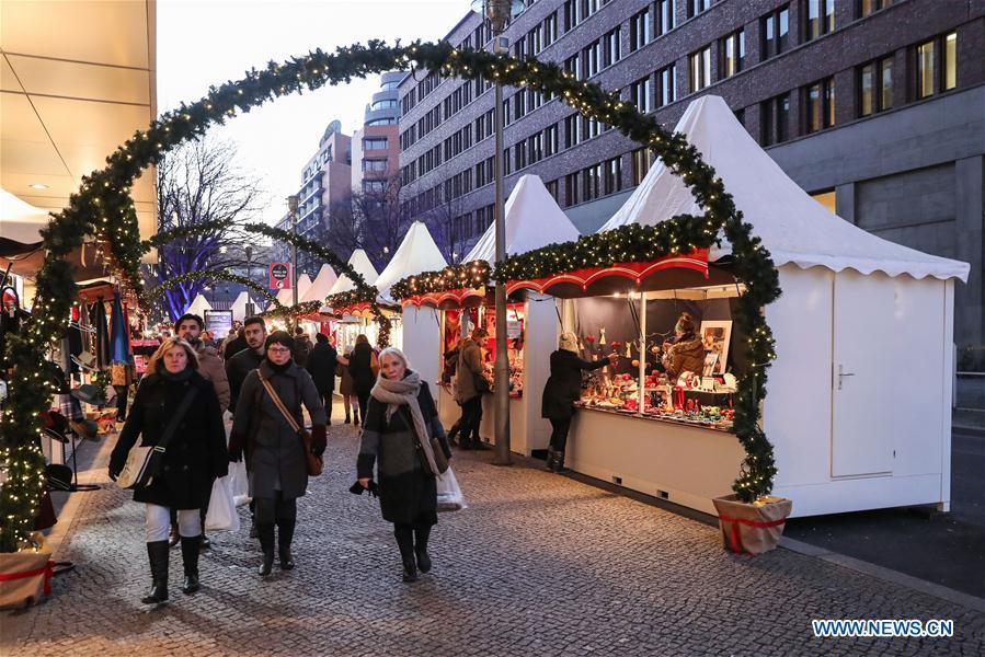 People wander through the reopened Christmas market at the Potsdamer Platz in Berlin, capital of Germany, on Dec. 21, 2016. Several Christmas markets in Berlin shut down due to safety concerns on Tuesday, were reopened on Wednesday. (Xinhua/Shan Yuqi)