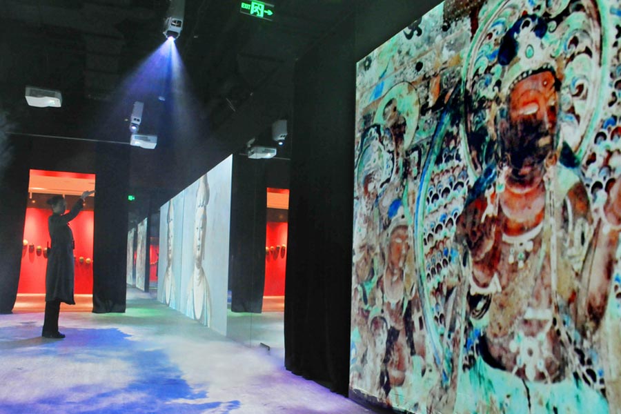 The images of Dunhuang frescoes are displayed on electronic screens at Shanghai Dashijie on Dec 28, 2016. [Photo/VCG]