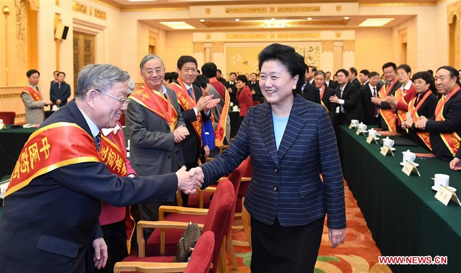 Chinese Vice Premier Liu Yandong (front R) shakes hands with renowned scholars recognized for their achievements in teaching traditional Chinese medicine in institutions of higher education, before a symposium with the scholars in Beijing, capital of China, Dec. 29, 2016. (Xinhua/Zhang Duo)