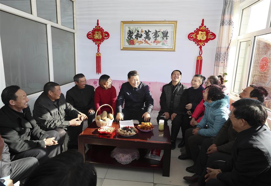 Chinese President Xi Jinping talks with villagers and local cadre at the home of villager Xu Haicheng in Desheng Village, Xiaoertai Township of Zhangbei County in north China