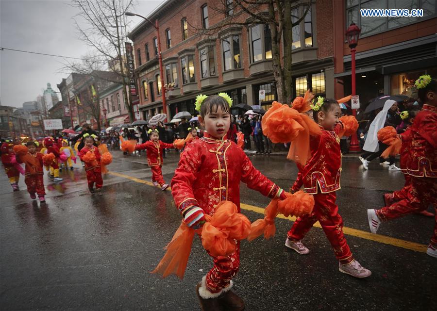 Children perform dancing during the Chinese Lunar New Year parade in Vancouver, Canada, Jan. 29, 2017. More than 70 parade troops with 3,000 participants paraded along the streets of Chinatown to celebrate the Year of the Rooster. (Xinhua/Liang Sen)