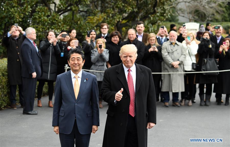U.S. President Donald Trump (R) and Japanese Prime Minister Shinzo Abe pose for a photograph as they walk to board Marine One departing for Andrews Air Force Base en route to West Palm Beach, Florida, after their joint press conference at the White House in Washington D.C., the United States, on Feb. 10, 2017. U.S. President Donald Trump said on Friday that his country will seek to promote a "fair and reciprocal" trade relationship with Japan. Trump made the remarks at a press conference after talks with visiting Japanese Prime Minister Shinzo Abe at the White House. (Xinhua/Yin Bogu)