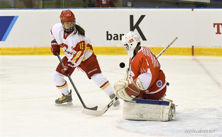 He Xin (L) of China takes a shot during the women