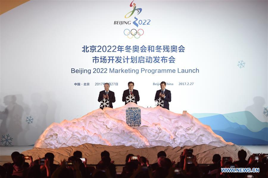 Beijing 2022 President Guo Jinlong (C), International Olympic Committee (IOC) Vice President Yu Zaiqing(L) and IOC Coordination Commission Chairman Alexander Zhukov clap after they put the white snowflake into a model of snow mountain to unlock the marketing program of Beijing 2022 Olympic and Paralympic Winter Games (Beijing 2022) in Beijing, capital of China, Feb. 27, 2017. The marketing program for Beijing 2022 was officially launched by the organizers here on Monday. (Xinhua/Ju Huanzong)