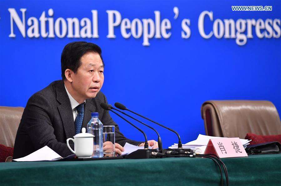 Chinese Minister of Finance Xiao Jie answers questions on reform of fiscal and taxation system and financial work at a press conference for the fifth session of the 12th National People