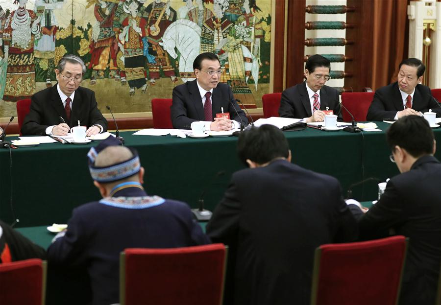 Chinese Premier Li Keqiang joins a panel discussion with deputies to the 12th National People