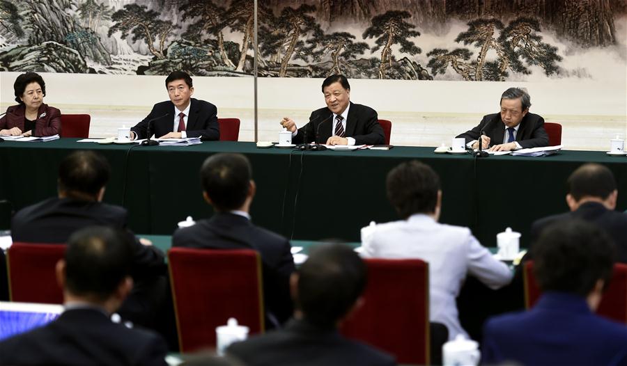 Liu Yunshan, a member of the Standing Committee of the Political Bureau of the Communist Party of China (CPC) Central Committee, joins a panel discussion with deputies to the 12th National People