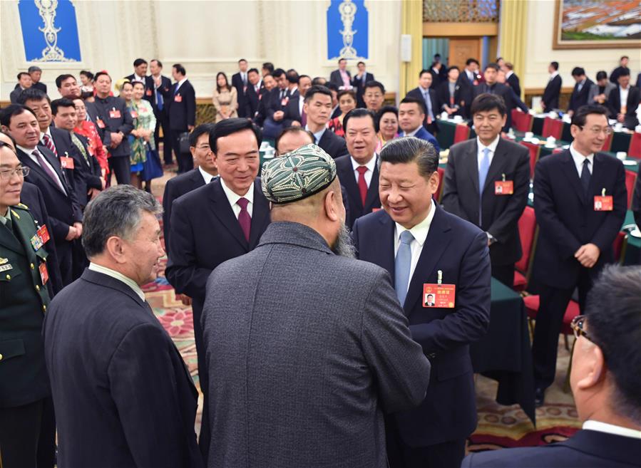 Chinese President Xi Jinping talks with deputies to the 12th National People