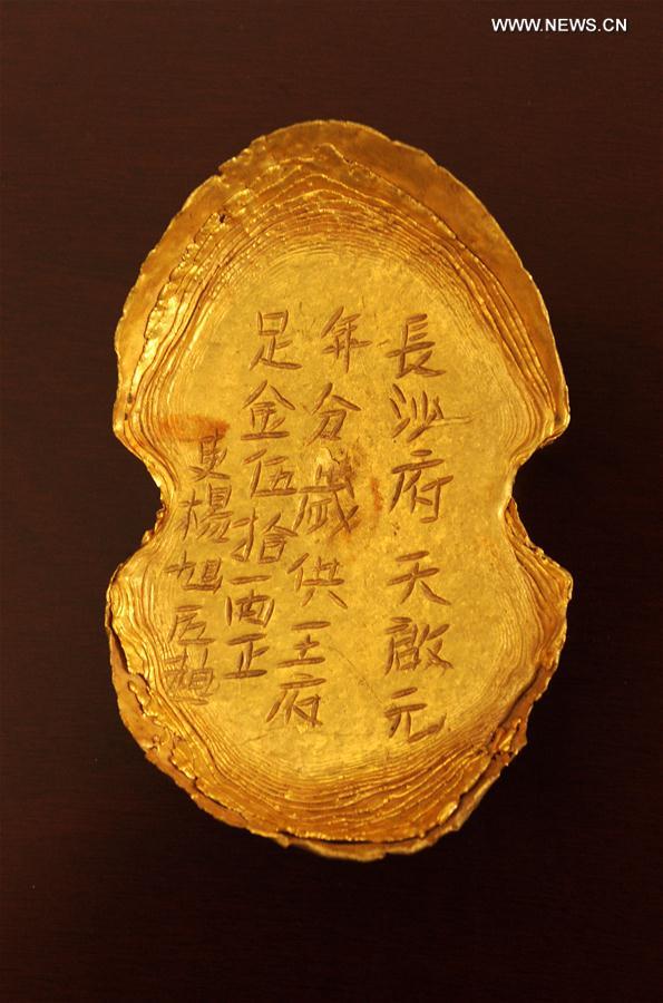 Photo taken on March 17, 2017 shows a golden ingot unearthed at Pengshan District in Meishan City, southwest China