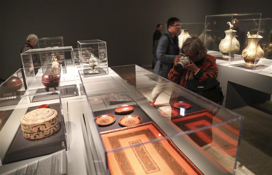A visitor takes photos of an artwork during a media preview of the Exhibition of Civilization of the Qin and Han Dynasties (221 B.C.-220 A.D.) in The Metropolitan Museum of Art, New York, the United States, on March 27, 2017. The exhibition featuring more than 160 objects of ancient Chinese art, will be opened to public from April 3 to July 16 in The Metropolitan Museum of Art. (Xinhua/Wang Ying)  