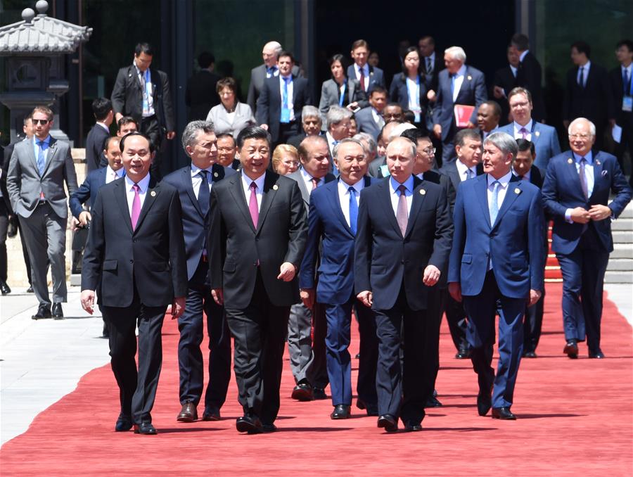 Chinese President Xi Jinping, foreign delegation heads and guests walk out of the Yanqi Lake International Convention Center after the first session of the Leaders