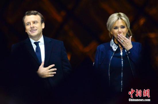 马克龙和妻子布丽吉特在巴黎卢浮宫前举行的庆祝胜选集会上。 <a target='_blank' href='http://www.chinanews.com/' width=