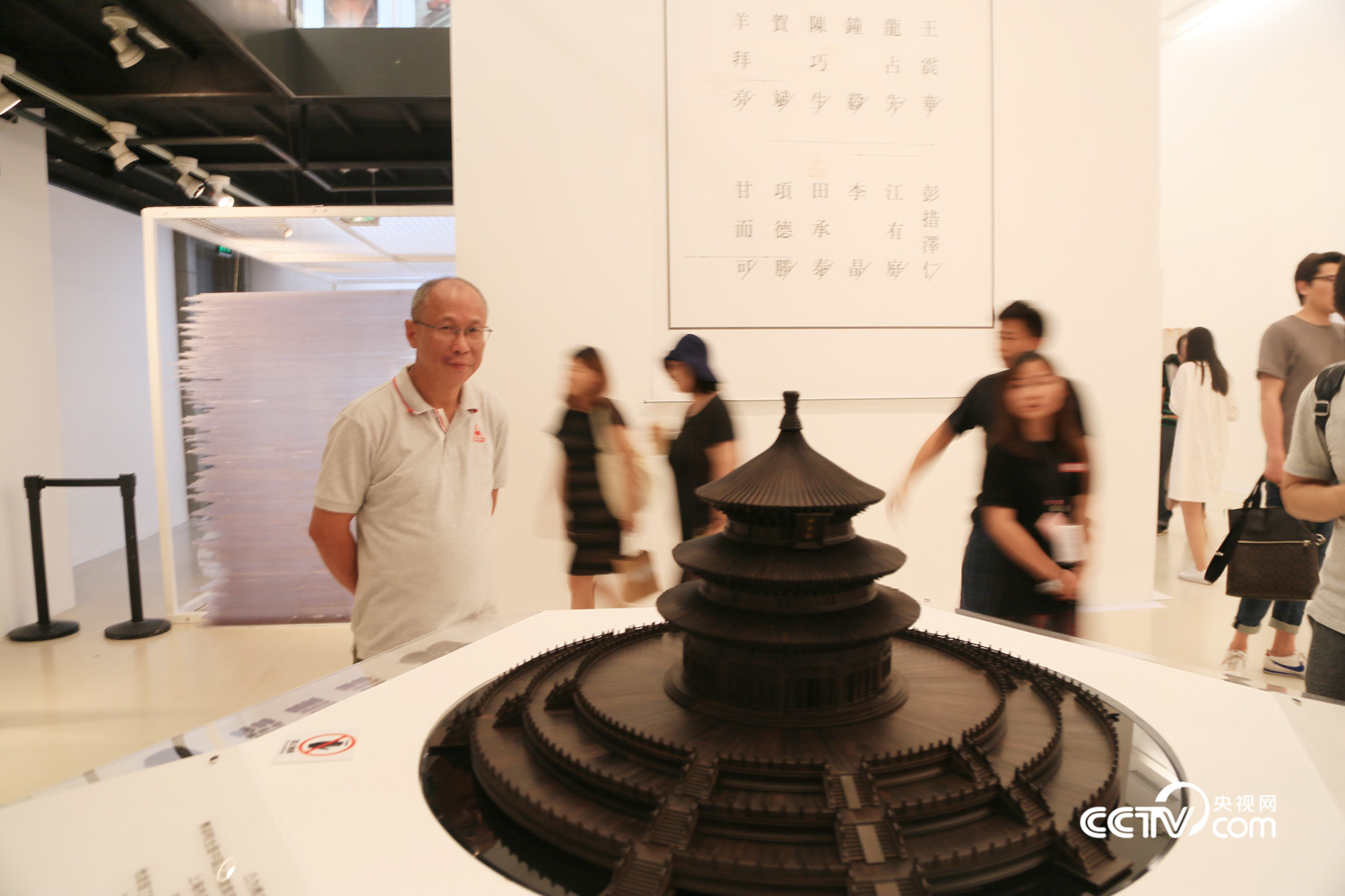 Craftsman Wang Zhenhua and his miniature model of the Hall of Prayer for Good Harvest