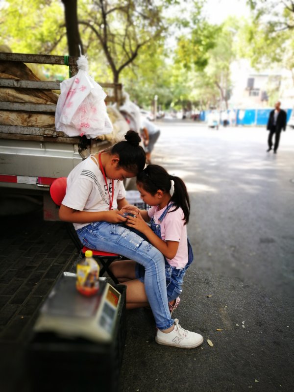 Two girls help their family sell fruit. Many people here prefer to buy fruit and vegetables from local farmers&rsquo; trucks, since they are considered to be cheaper and fresher than products in super markets. 
