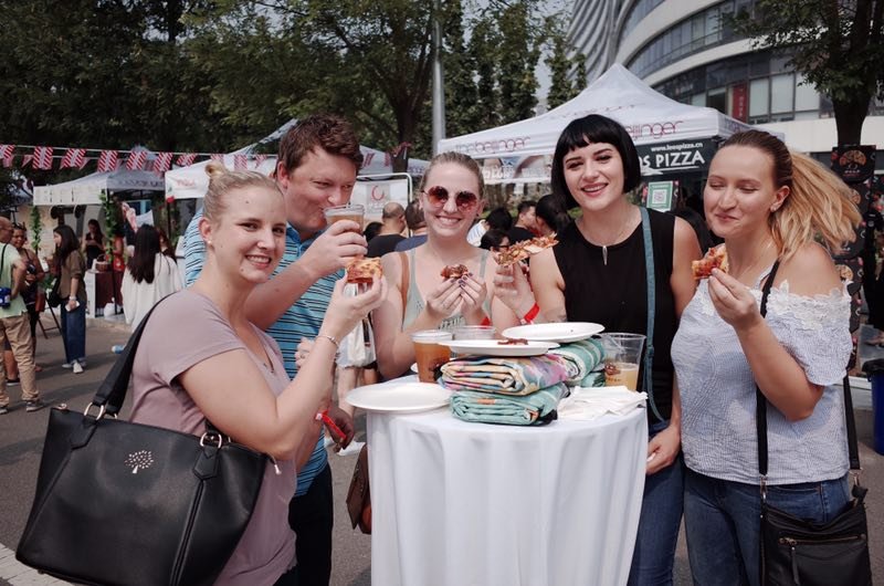 Attendees enjoying food. (Photo/ thebeijinger)
