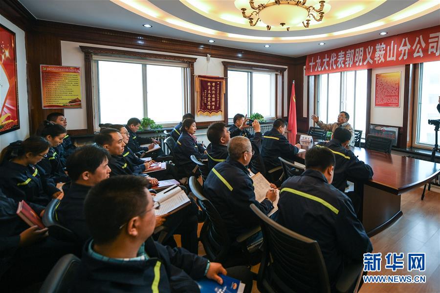 11月3日，郭明义（右三）在鞍钢矿业集团齐大山铁矿采场与工友交流制定修路方案。